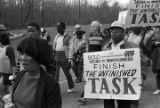 Marchers during the 20th anniversary reenactment of the Selma to Montgomery March, probably in rural Dallas or Lowndes County, Alabama.