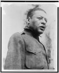 [Bert Williams, head-and-shoulders portrait, standing, facing right, singing a psalm at the first regimental open air service for the 15th Regiment of the New York National Guard, held in Olympic Field, 136th Street and Fifth Avenue, New York City]