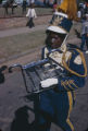 Member of the Booker T. Washington High School marching band carrying a bell lyre during a homecoming parade in Montgomery, Alabama.