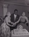 Photographs of Nat King Cole cutting a cake with Zsa Zsa Gabor