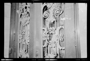 Close up of door with a demonstrator in the window of the Administration Building at Boston University