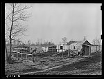 Farmstead of Negro sharecropper with sharecropper carrying water. Near Transylvania, Louisiana