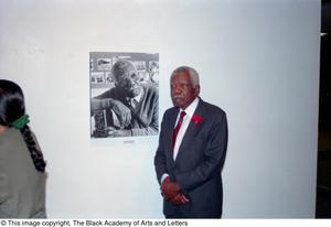 Marion Butts posing with his portrait