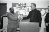 Robert A. Wild shakes hands with Milwaukee Chief of Police Arthur L. Jones, 1997