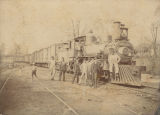 Men standing in front of a train, probably part of the Southern Railway.