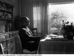 Photograph of Rev. James Garfield Owens in his dinging room