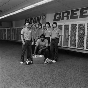 Football staff posing with equipment, 6