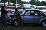 Male group sitting on Volkswagen automobile