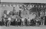 Copy photograph of bales of cotton on a wagon outside the Bullock Warehouse in Bullock County, Alabama.