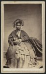 [Full-length portrait of an African American woman holding a basket]