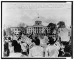 [Selma to Montgomery marchers wave American flags in front of the Alabama State Capitol at the end of their 5 day march]