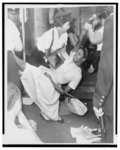 [African American woman being carried to police patrol wagon during demonstration in Brooklyn, New York]