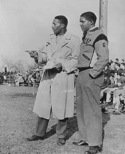 Louis House of Hallie Q. Brown, in coat, at a football game.