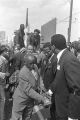 T. Y. Rogers and Jesse Jackson on the cart carrying Martin Luther King, Jr.'s casket during the funeral procession on Auburn Avenue.