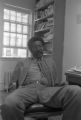 John Blassingame: New York. John Blassingame seated in office, Fredrick Douglas portrait on the wall (BLJP 1-79 #101)