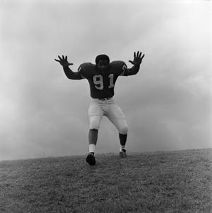 NTSU football player with hands raised, 10