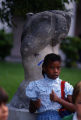 Student standing in front of sculpture