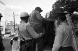 Police officers arresting a civil rights demonstrator during the Children's Crusade in Birmingham, Alabama.