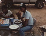 Members of the American Agriculture Movement eating barbecue at a gathering on Oscar Belvin’s farm in Montezuma, Georgia.