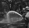 Firemen spraying civil rights demonstrators with a hose at Kelly Ingram Park during the Children's Crusade in downtown Birmingham, Alabama.