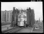 Workers cleaning Zephyr diesel engine car, 14th Street passenger yards, Chicago, May 1948