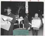 Mississippi State Sovereignty Commission photograph of J. C. Killingsworth, Clarence Clay and James Cedarstrium (left to right) standing on a sidewalk during a demonstration protesting Secretary of Defense Robert McNamara's visit to Jackson, Mississippi, 1960s