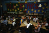 Group of students seated in front of "all stars" mural