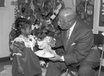 Children's Collective guest Gilbert Lindsay receiving a gift., Los Angeles, 1987