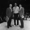 Joe Louis with two men before or after refereeing a wrestling match between Tojo Yamamoto and Saul Weingeroff at the city auditorium in Birmingham, Alabama.