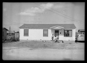 Photograph of Two Men in Front of a Building