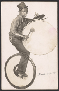 Postcard of a performer playing a drum while on a unicycle