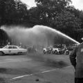 Firemen spraying civil rights demonstrators with a hose at Kelly Ingram Park during the Children's Crusade in downtown Birmingham, Alabama.