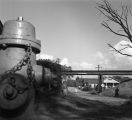 Street passing under a railroad bridge.