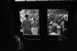 Dorothy Frazier addressing a crowd from the stoop of a brick building at Alabama State College in Montgomery, Alabama, during a student demonstration.