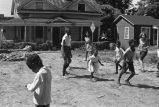 Children playing in vacant lot.