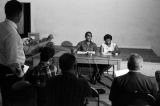 Richard Boone and Idessa Williams seated at a table in front of journalists during a press conference in Montgomery, Alabama.