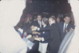 George and Lurleen Wallace walking through a crowd at a rally in the Municipal Auditorium in Birmingham, Alabama, during Lurleen's gubernatorial campaign.