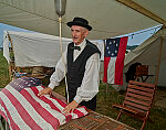 Costumed character Ralph Aitkin at the re-enactment, held each American Independence Day Weekend (on and surrounding July 4), of various skirmishes at the decisive 1863 Battle of Gettysburg, in Pennsylvania, which turned the tide of the American Civil War against the outmanned, rebellious Confederates for good. Mr. Aitkin, who lives in Lewiston, Pennsylvania, portrays an embalming surgeon, an indepedent provider of embalming services for the deceased of both armies during the bloody conflict