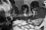 Southern Courier staff members judging contest entries in a house or apartment in Montgomery, Alabama.