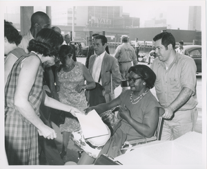 Woman in wheelchair receives paper