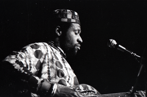 Thumbnail for Taj Mahal in concert at Northfield, Mass.: Taj Mahal seated, playing steel guitar