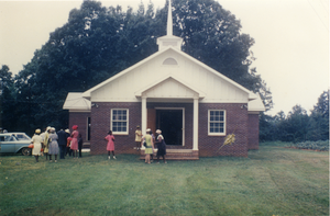 Church members in front of rebuilt Antioch Church, Blue Mountain, Miss.