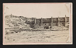 [Inside view of a fort after the battle, possibly Sumter, with four visitors near the fortified walls]