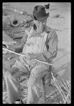 [Untitled photo, possibly related to: Mixed-breed Indian, white and Negro, near Pembroke Farms, making new chair seat. North Carolina]