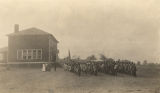 African American students and faculty lined up outside the main building of the training school in Lowndes County, Alabama.