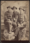 [Three unidentified Civil War veterans in Grand Army of the Republic uniforms with swords in front of painted backdrop]