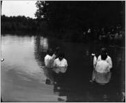 African American woman is baptized.