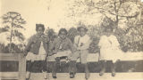 Four African American children sitting on a fence in Wilcox County, Alabama.