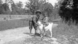 Two African American children with a goat in rural Wilcox County, Alabama.