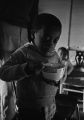 Young boy of the Turner family in Montgomery, Alabama, eating out of a bowl.